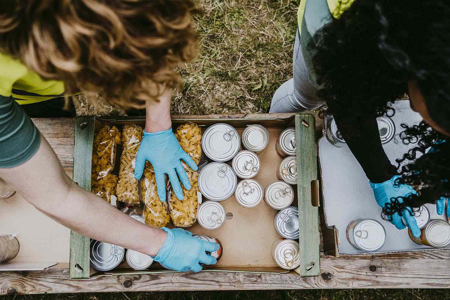  friends arranging food in cardboard boxes for Non-profit insurance