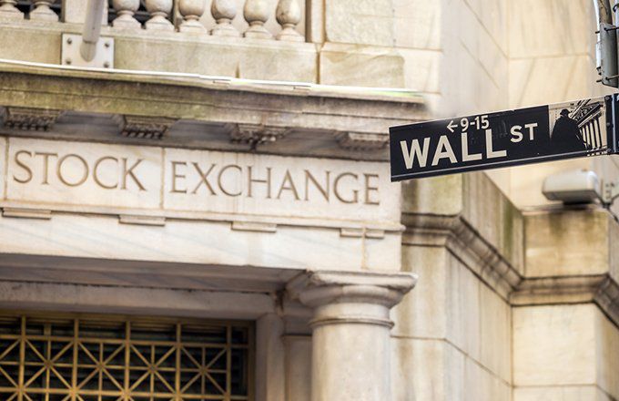 A Wall Street street sign in front of the New York Stock Exchange