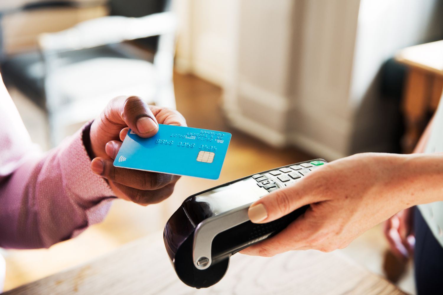 Person using contactless payment credit card