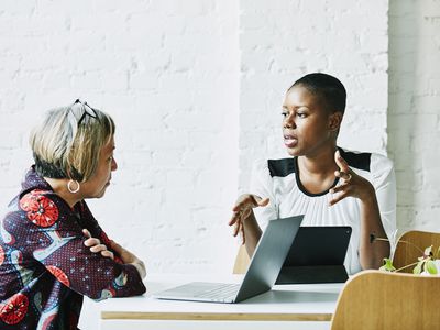 Female financial advisor in discussion with client in office conference room