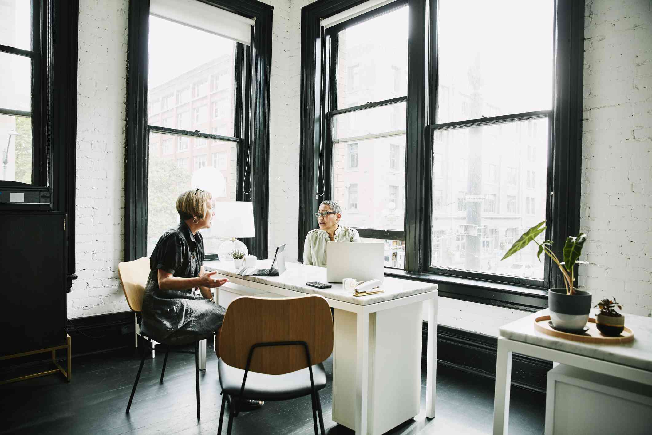 Financial advisor speaking to a client in a modern office