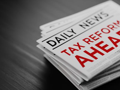 Tax Reform Concept Newspaper Pile On Black Wood Surface