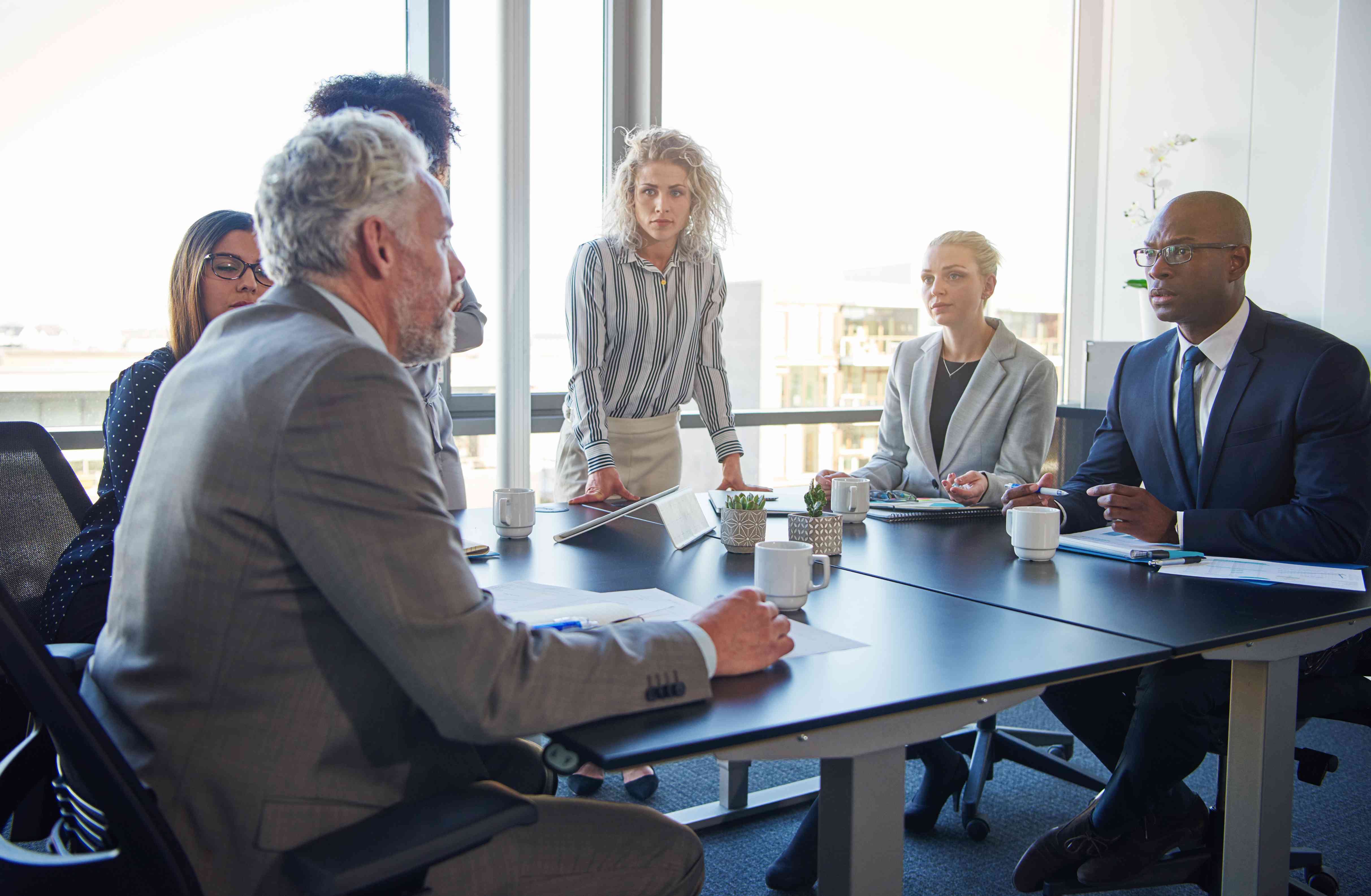 People in a business meeting discussing reinsurance policies