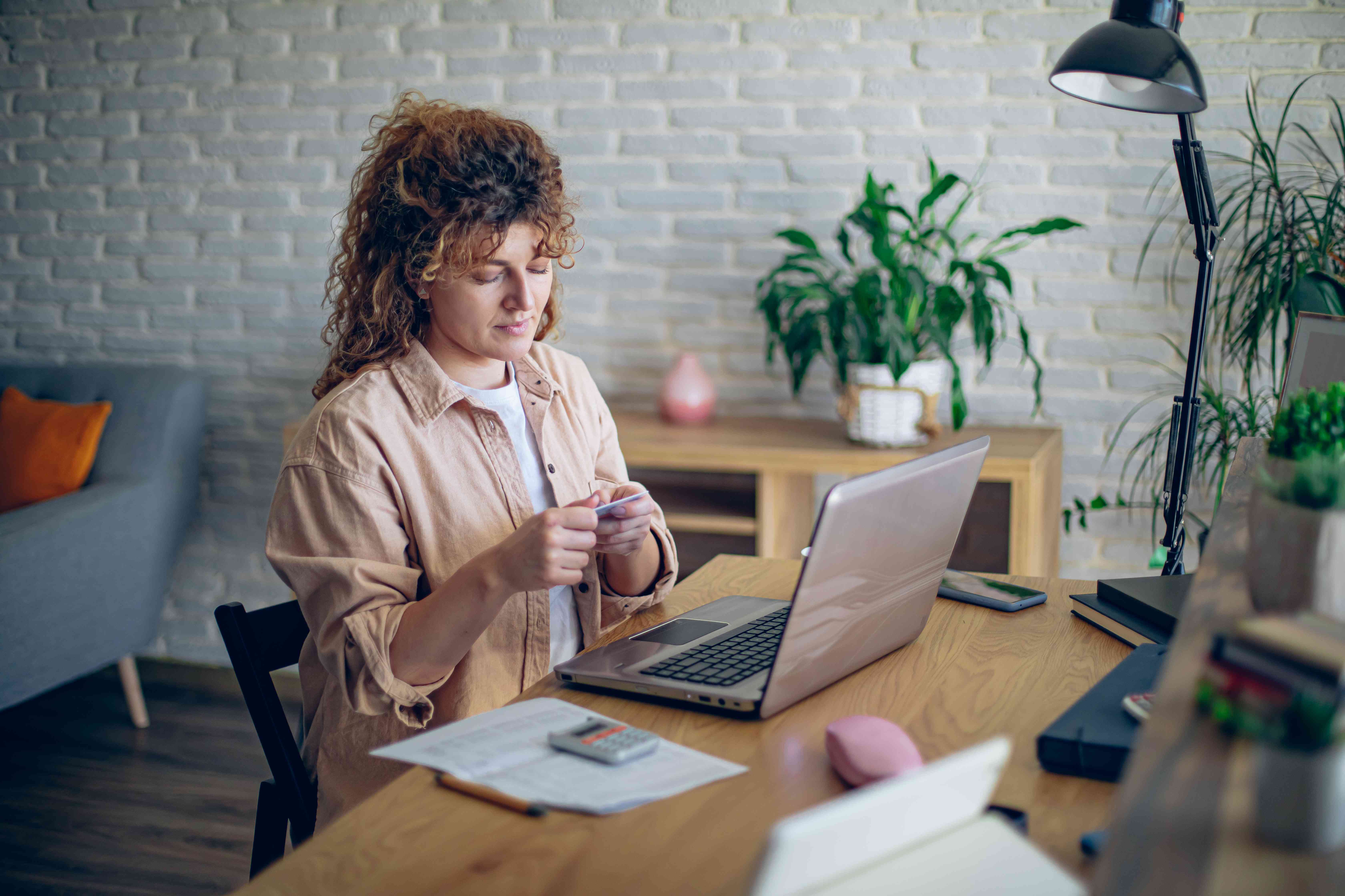 Woman opening an online checking account on her laptop