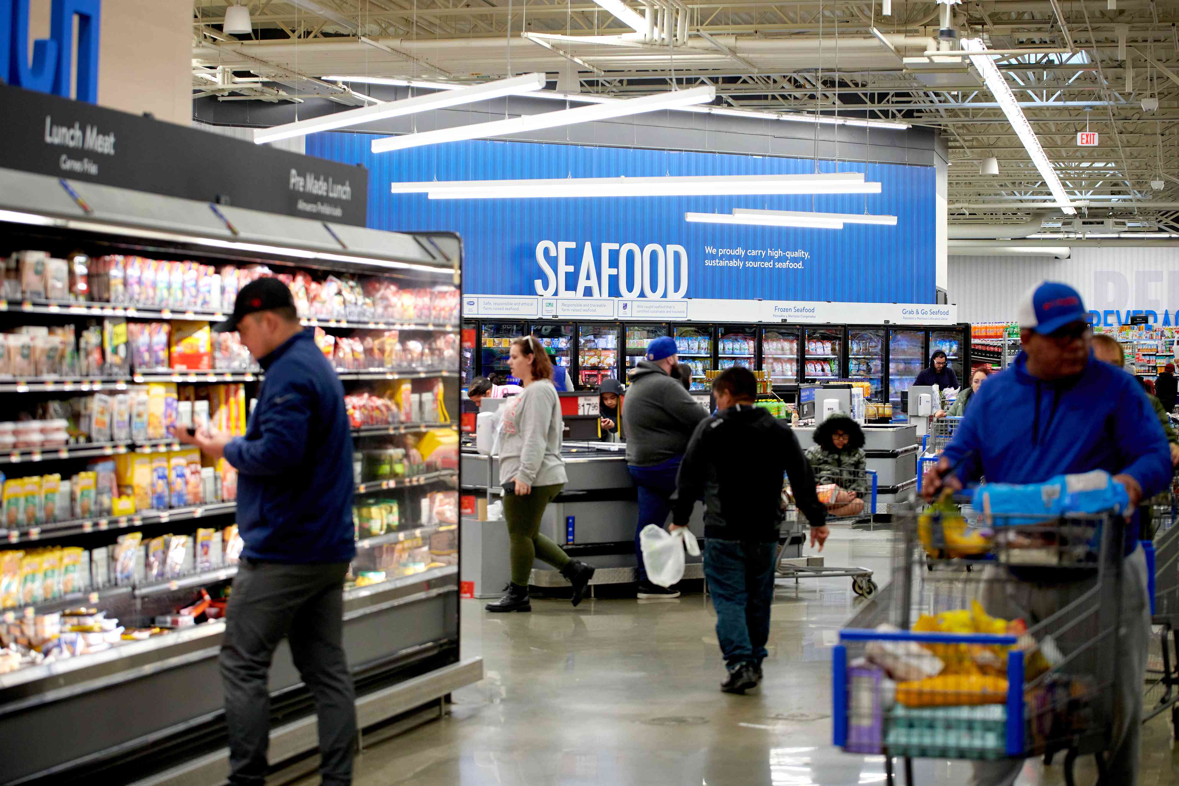 Customer's shop for groceries at a Walmart store in Secaucus, New Jersey, US, on Tuesday, March 5, 2024. 