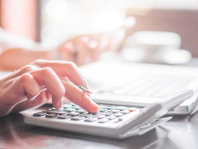 Woman with calculator, papers