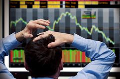 Stock trader watches stocks crash on screen