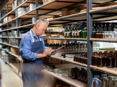 Person in a warehouse taking inventory of stock