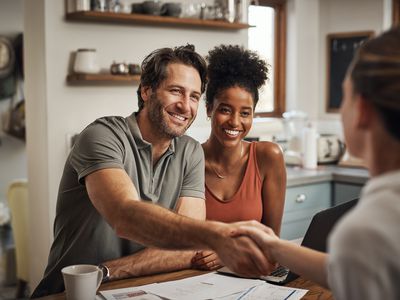 A couple finishes signing paperwork for a home equity loan