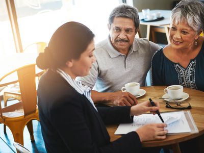 senior couple speaking with insurance agent