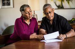 A couple looking at paperwork at a table