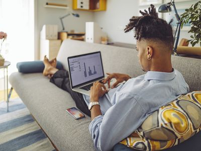 Young man working at home with accounting software