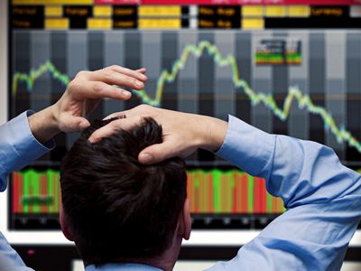 Stock trader watches stocks crash on screen