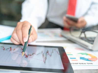 Businessman Using a Mobile Device to Check Market Data