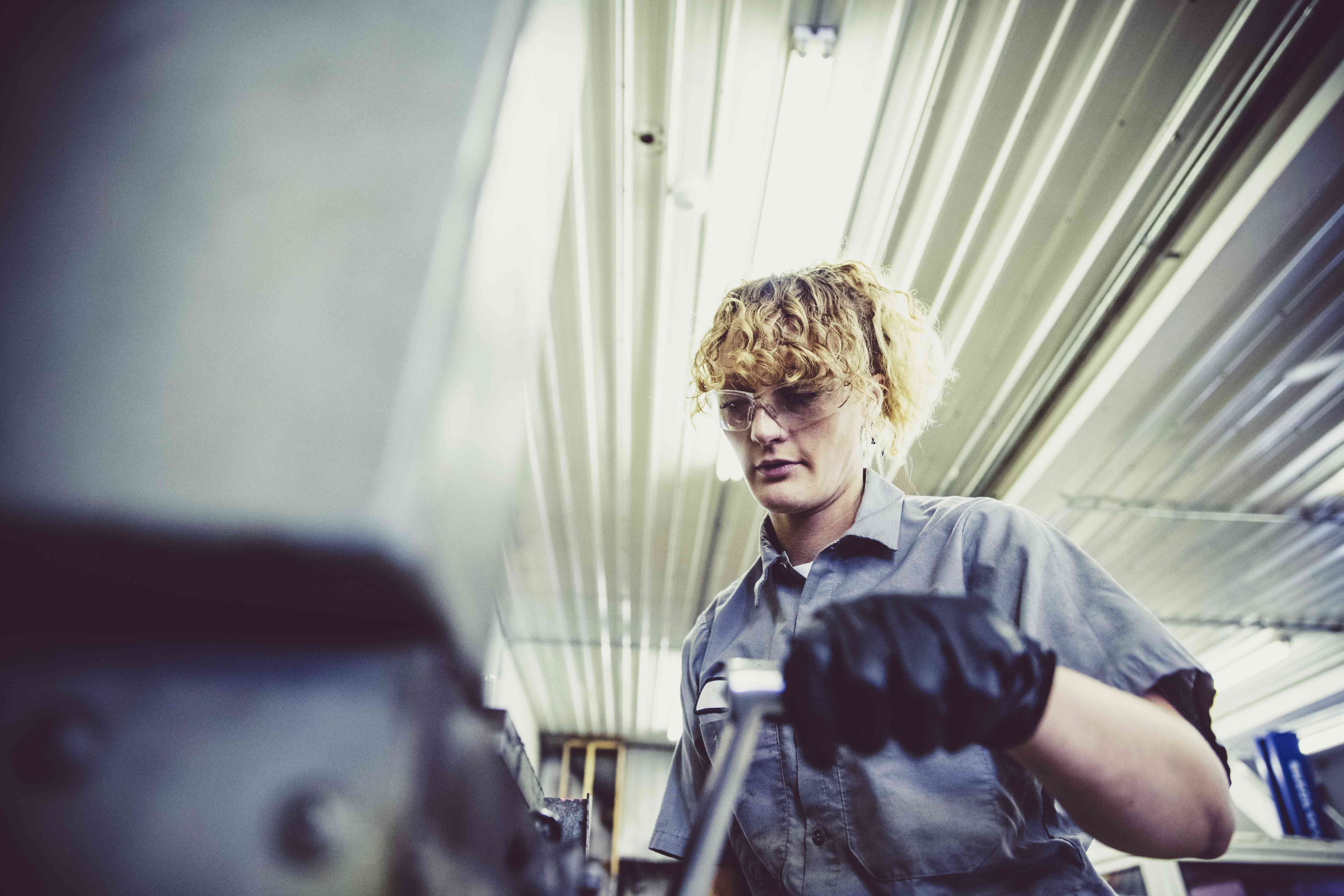 Person working as a mechanic in a garage