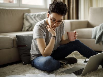 Young woman working at home on her laptop. 