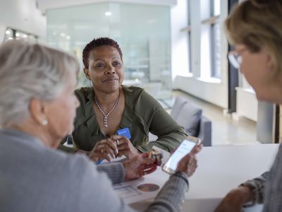 financial meeting with mother and daughter using smart phone in bank