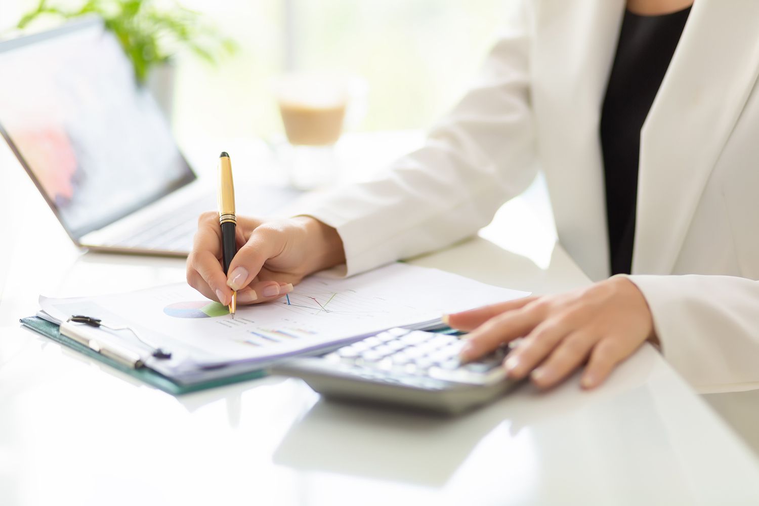 Close up Hands of Businessman Working With Business Document and Laptop on the Table