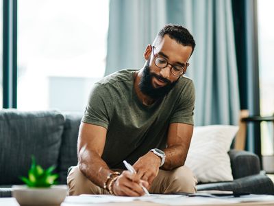 A man fills out paperwork.