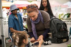 A white woman and her daughter shopping with EBT coupons, also known as food stamps, represent the largest racial group that benefits from SNAP in the U.S.