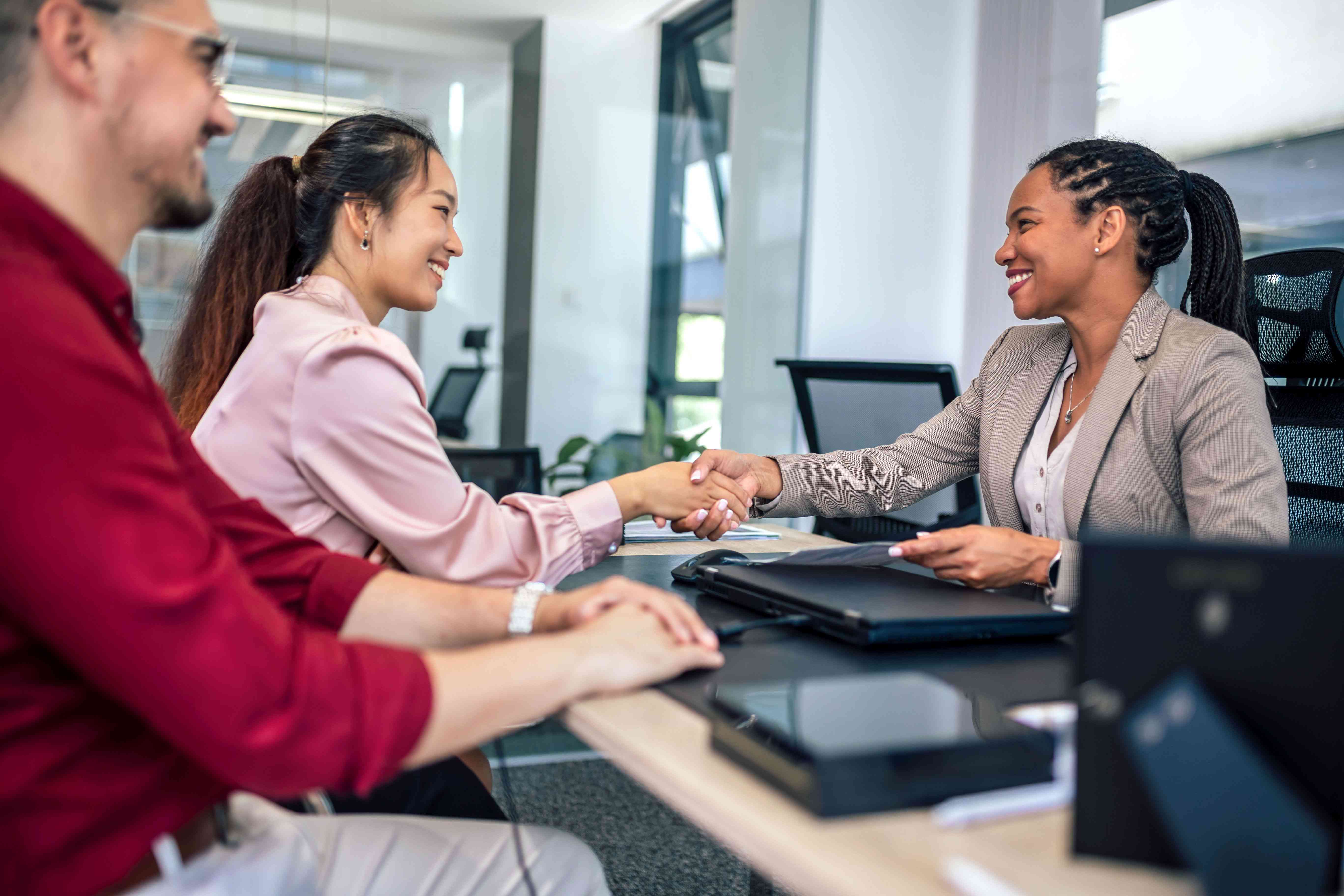 Two people meeting with a third in an office