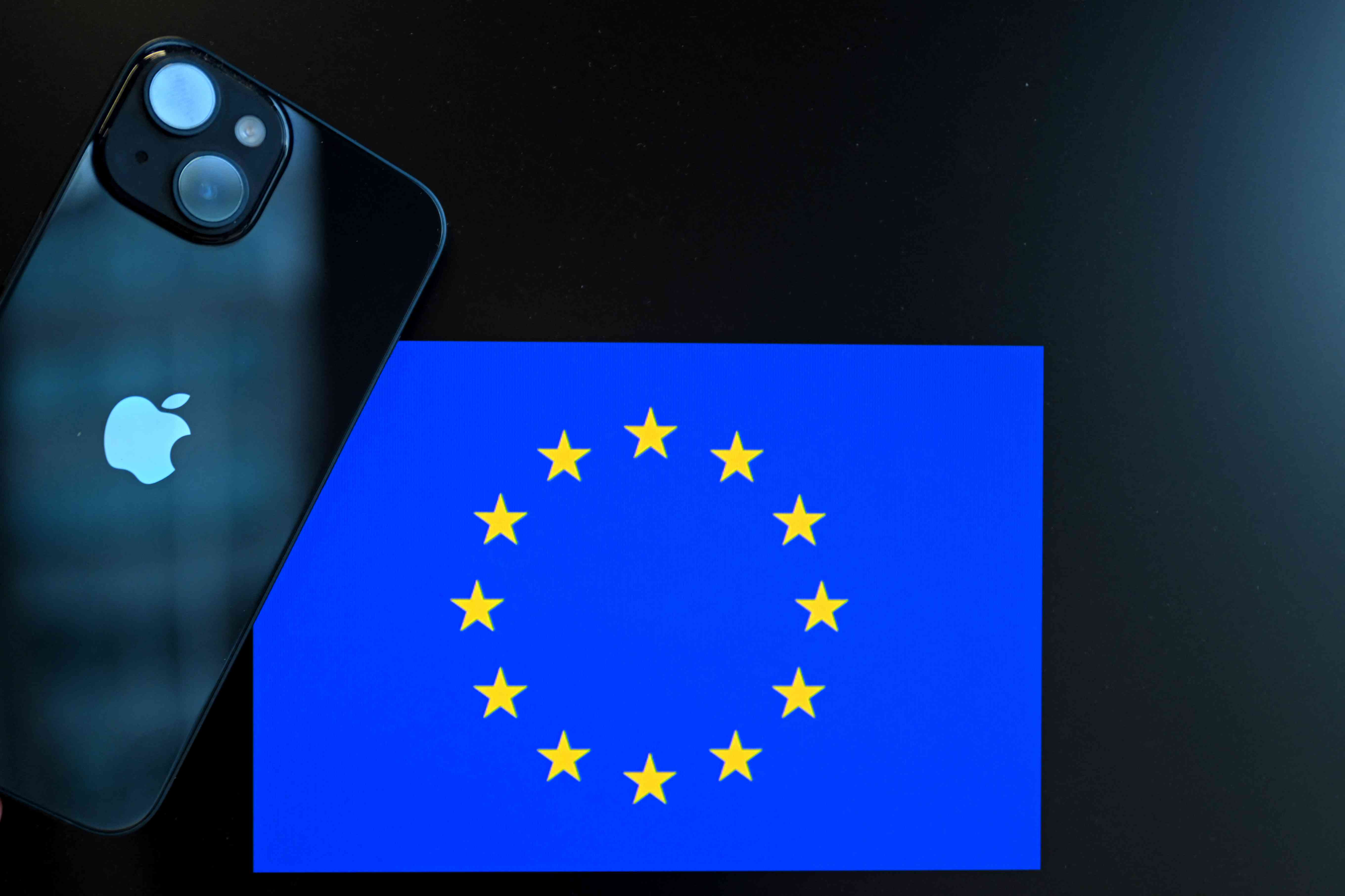 a smartphone with the Apple company logo and the European Union logo