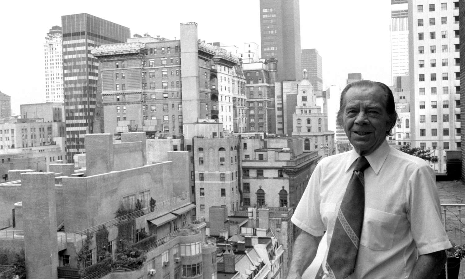 A photo of Willie Sutton standing on a rooftop with the skyline in the background in Manhattan New York.