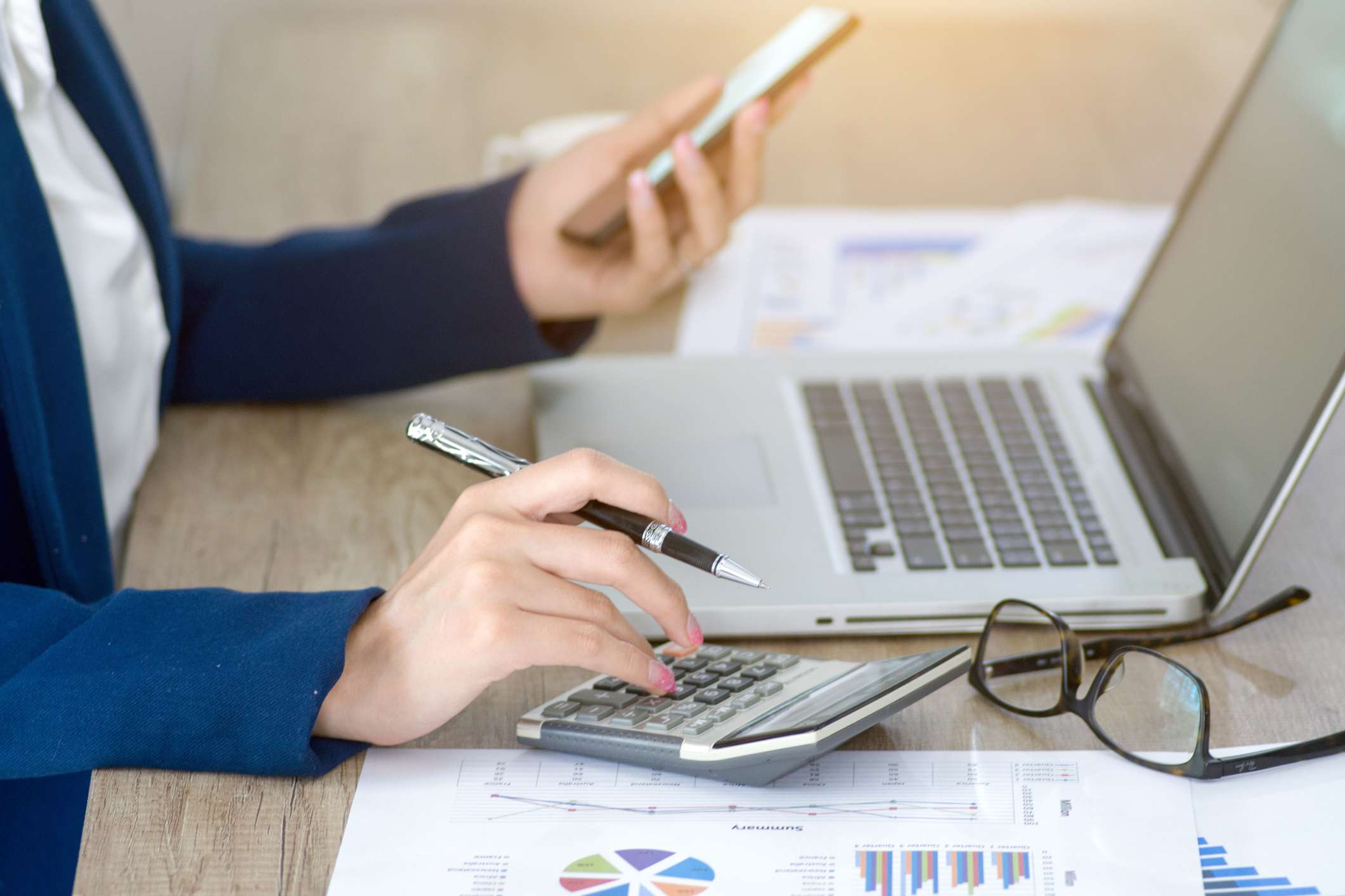 accountant at desk with computer and calculator