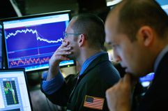  Traders work on the floor of the New York Stock Exchange at the end of the trading day