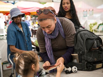 A white woman and her daughter shopping with EBT coupons, also known as food stamps, represent the largest racial group that benefits from SNAP in the U.S.