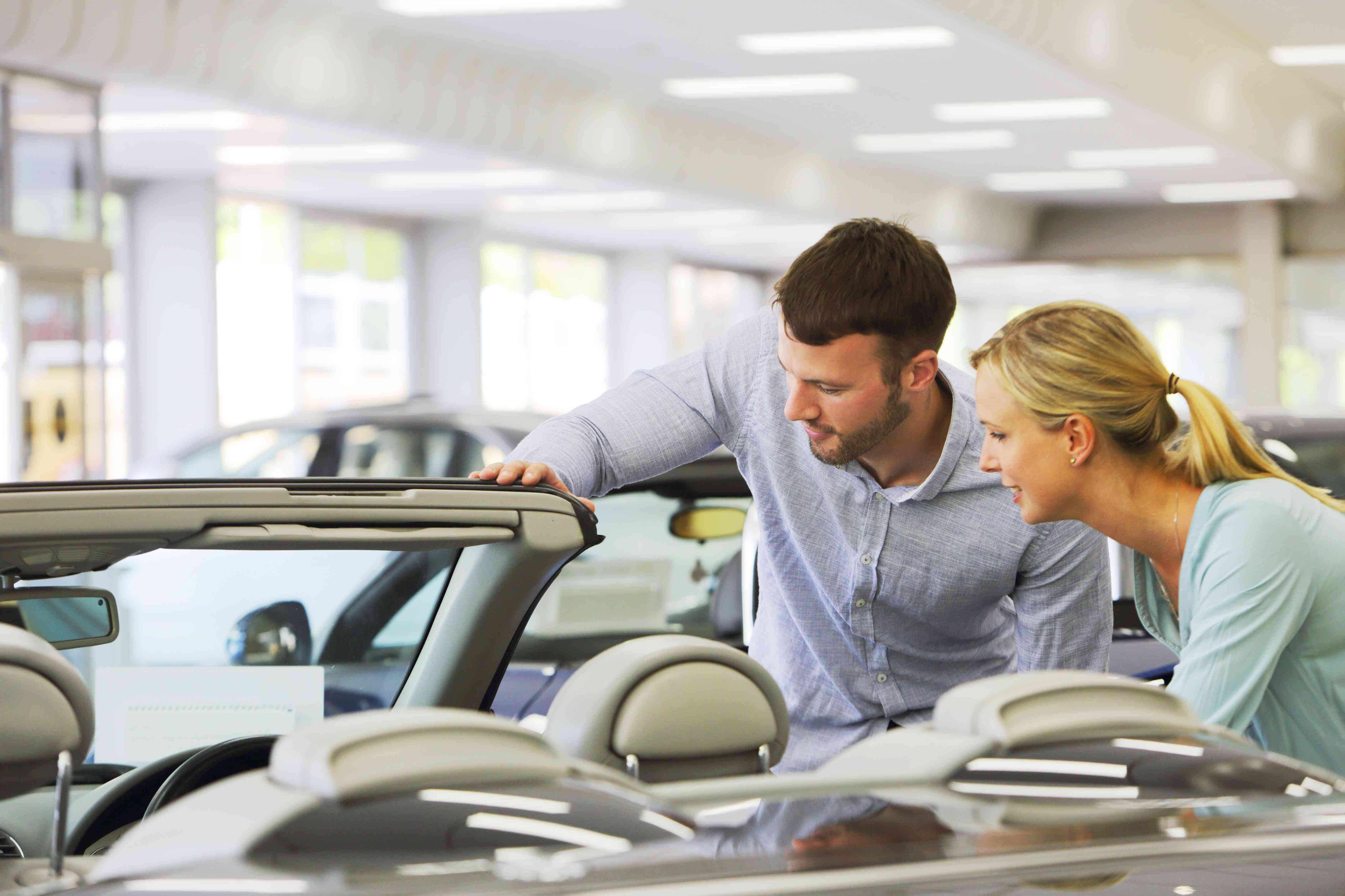 A couple looks at cars.