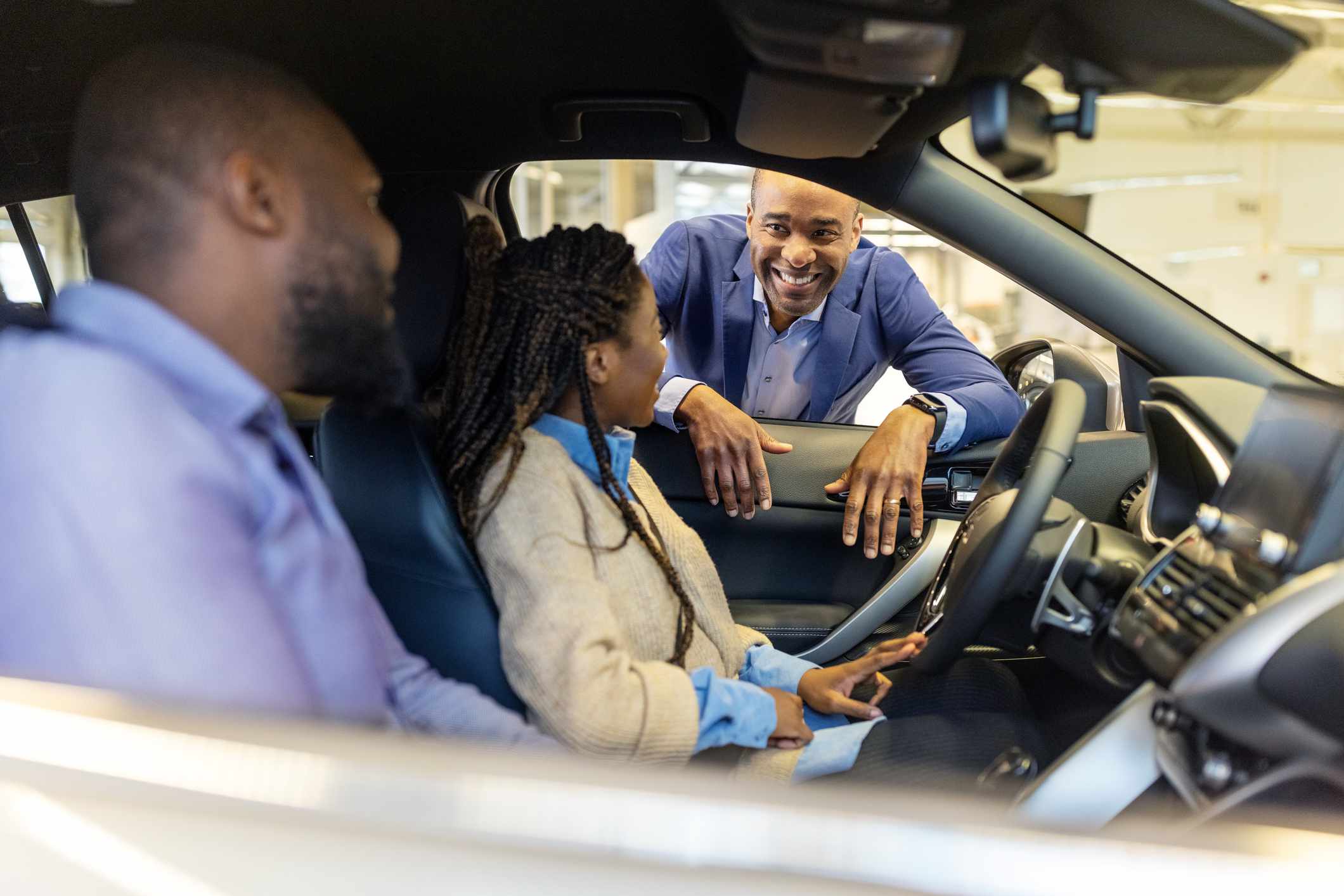 Couple sitting in new car