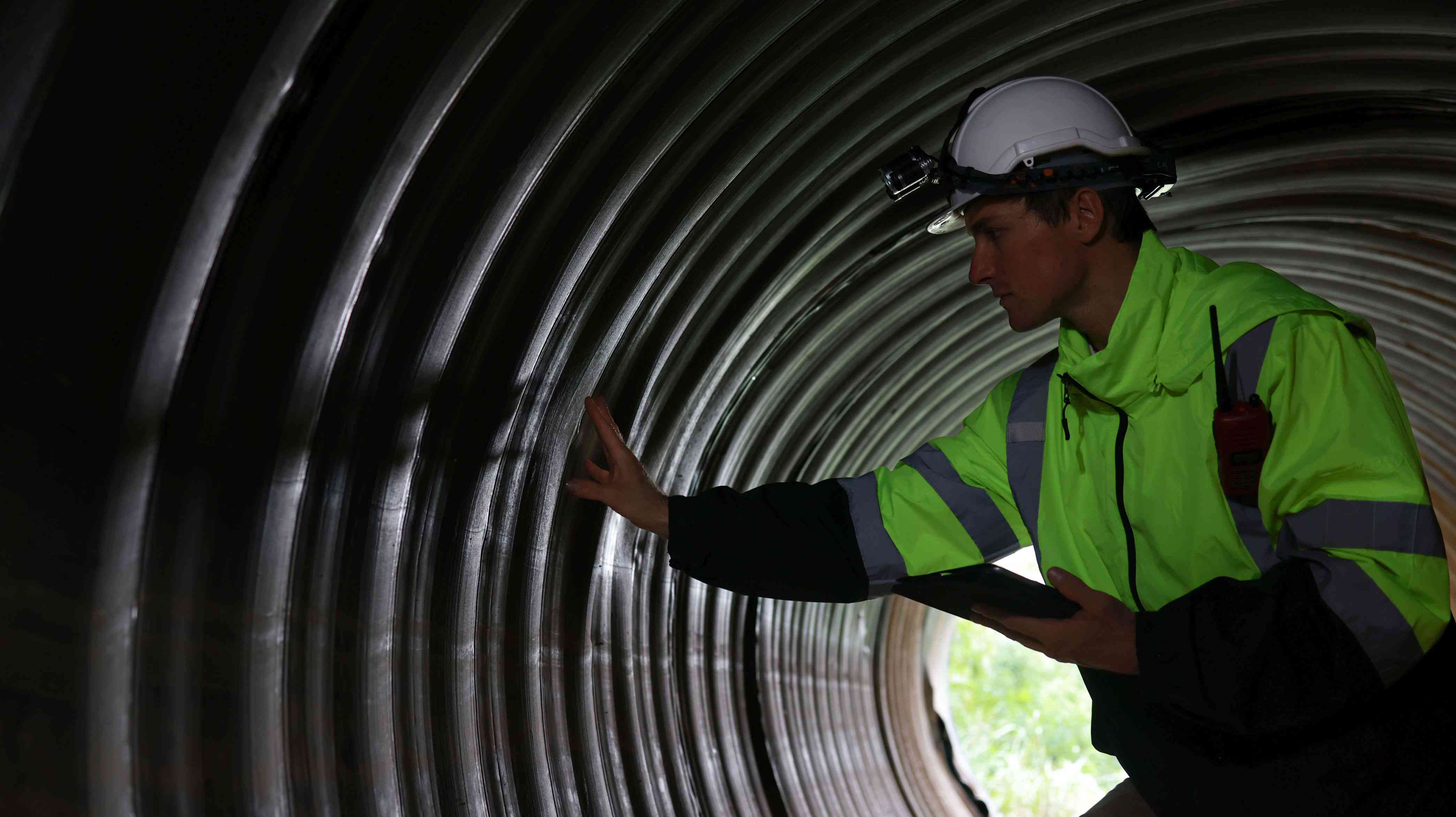 Engineer checking the inside of a city drainage pipe