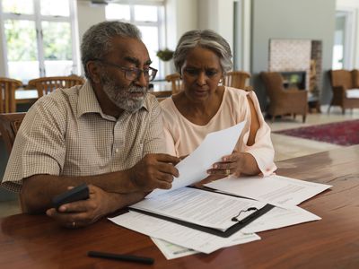 Senior couple discussing paperwork at home