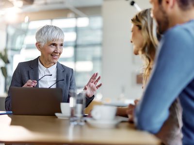 A broker talks to a couple.