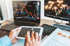 Businessman Analyzing Stock Market Data Over Digital Tablet In Office