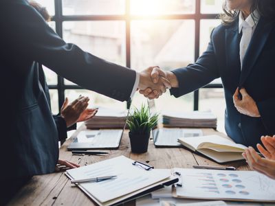 Business people shaking hands to congratulate success.