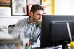 A man uses a desktop computer.