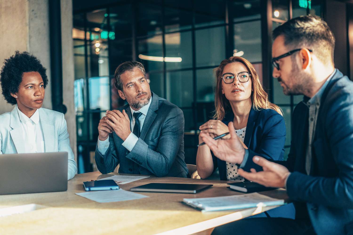 The fund managers for an ultra-short bond fund discuss investment options and risk during a meeting.