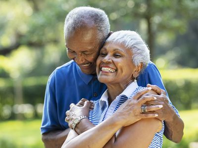 Older couple smiling outside