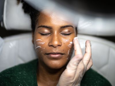 Young woman doing a facial treatment at a spa