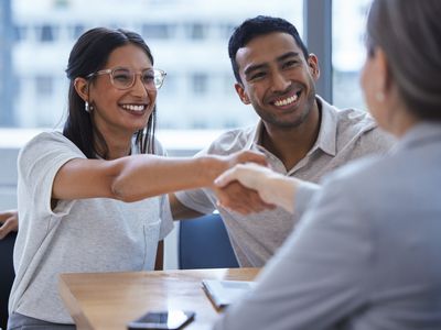 Couple shakes hands with a banker