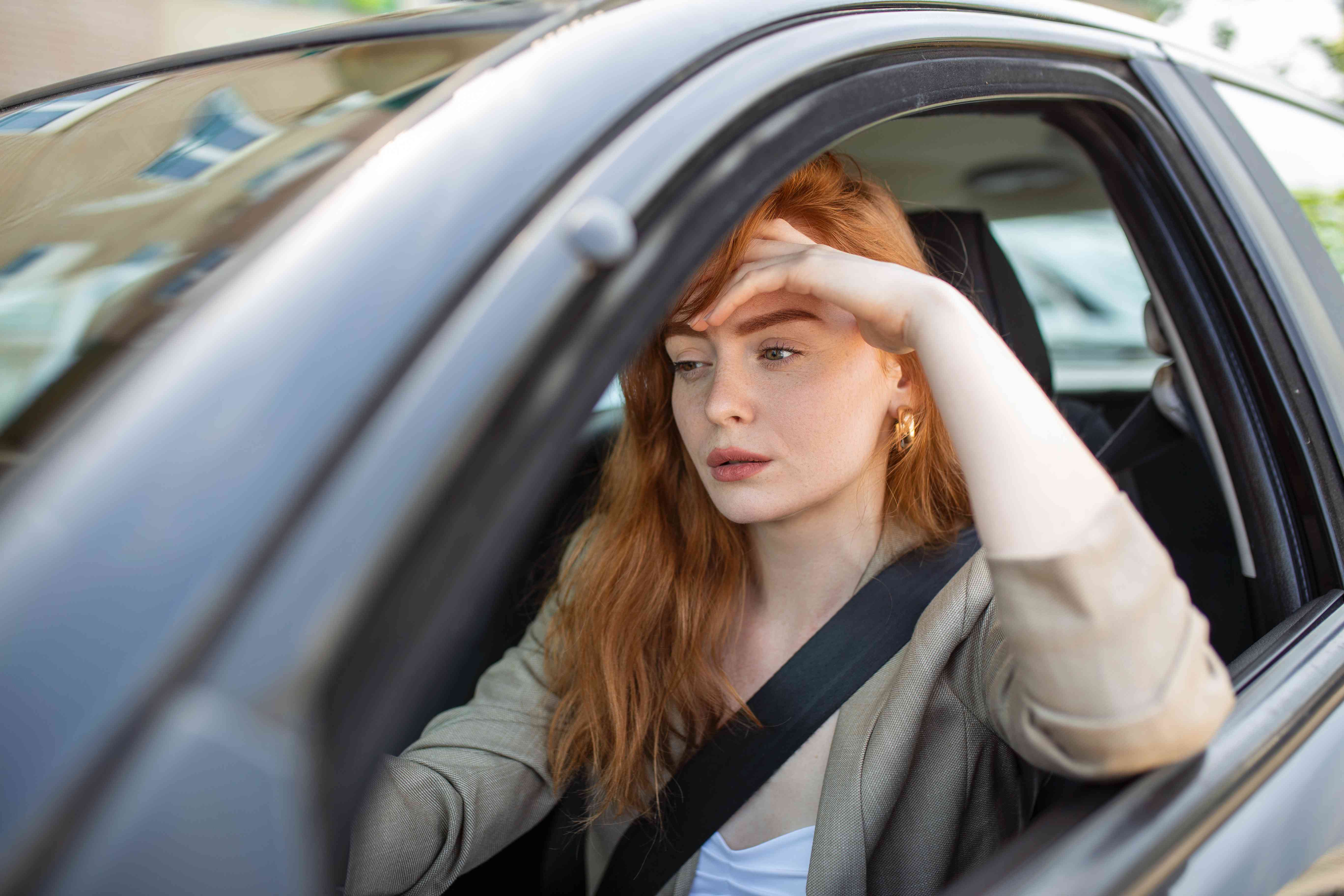 A driver of a car seems worried.