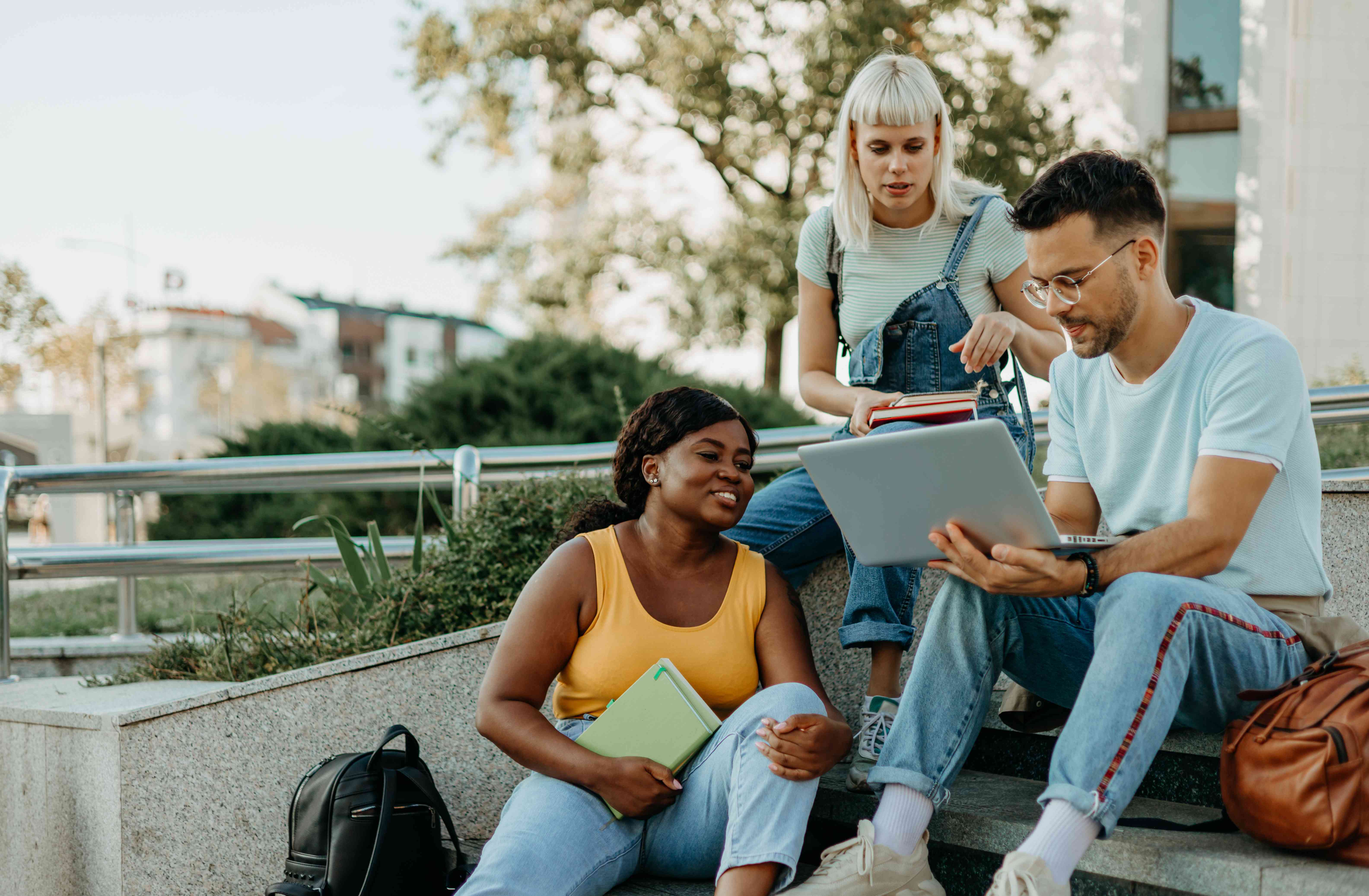 Group of friends calculating how their student loans affect their debt-to-income ratios