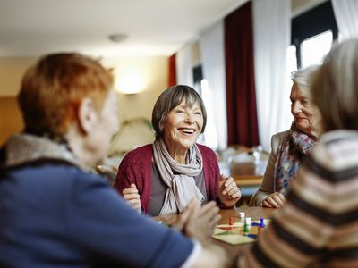 Senior women playing a board game indoors