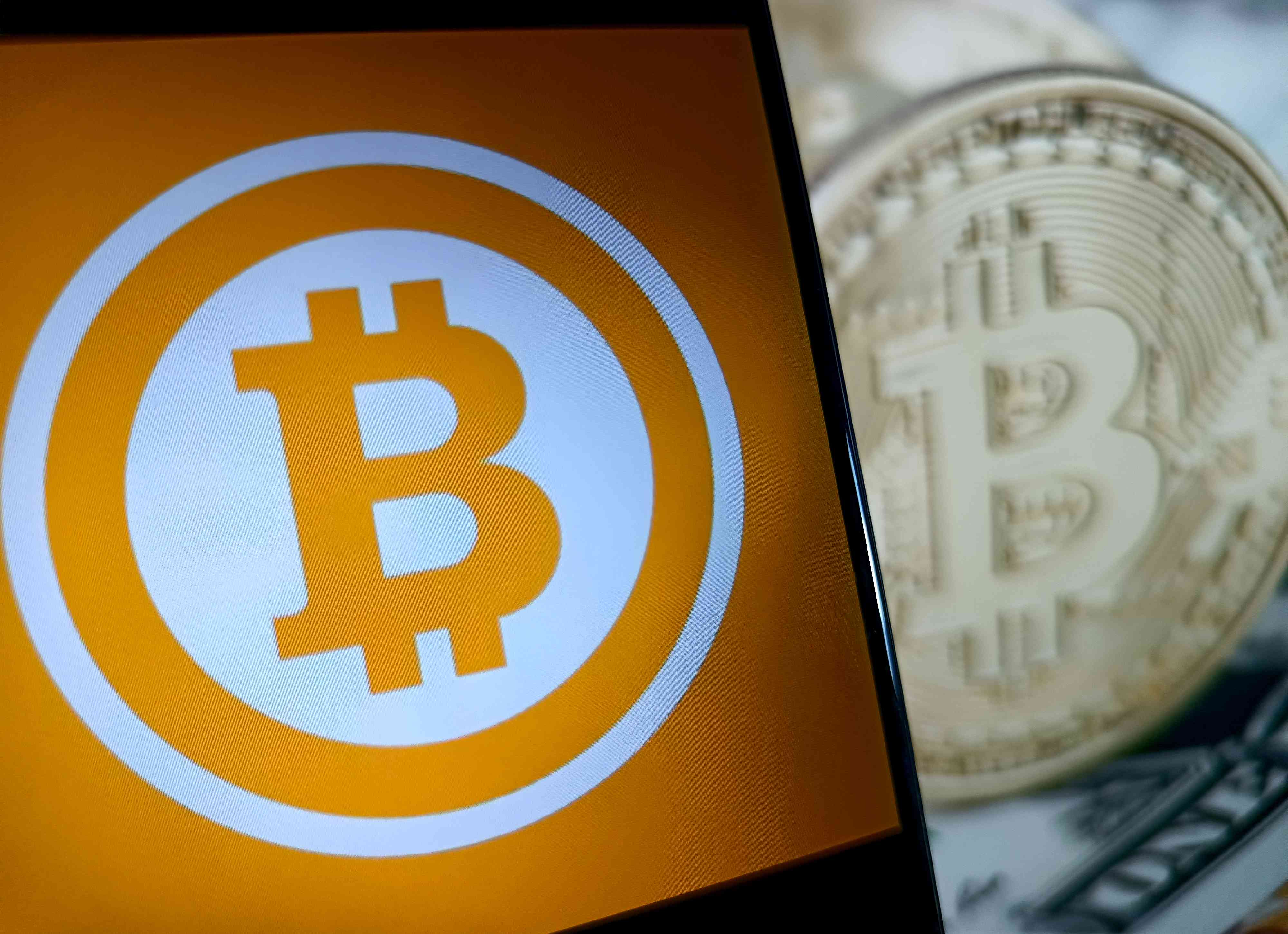 An illustration of a bitcoin logo and a golden physical bitcoin. 