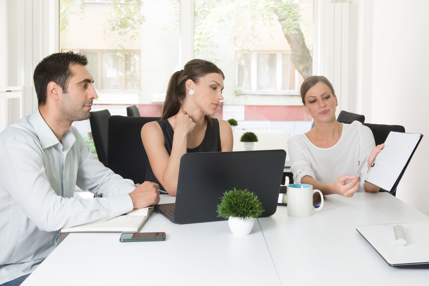 Group of ambitious young professionals working together on their joint project.