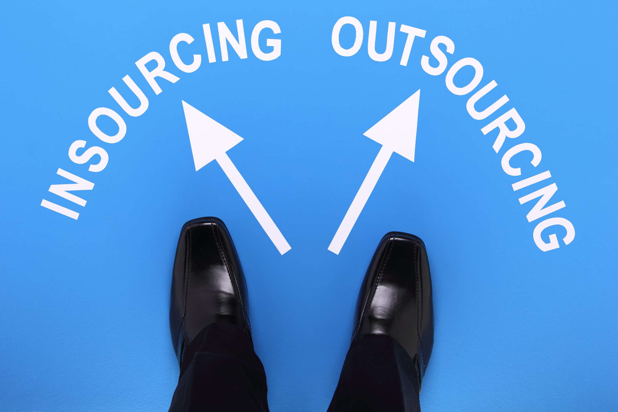 Unrecognizable businessman choosing between insourcing and outsourcing.