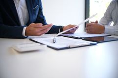 accountant Discussing With Client At Desk