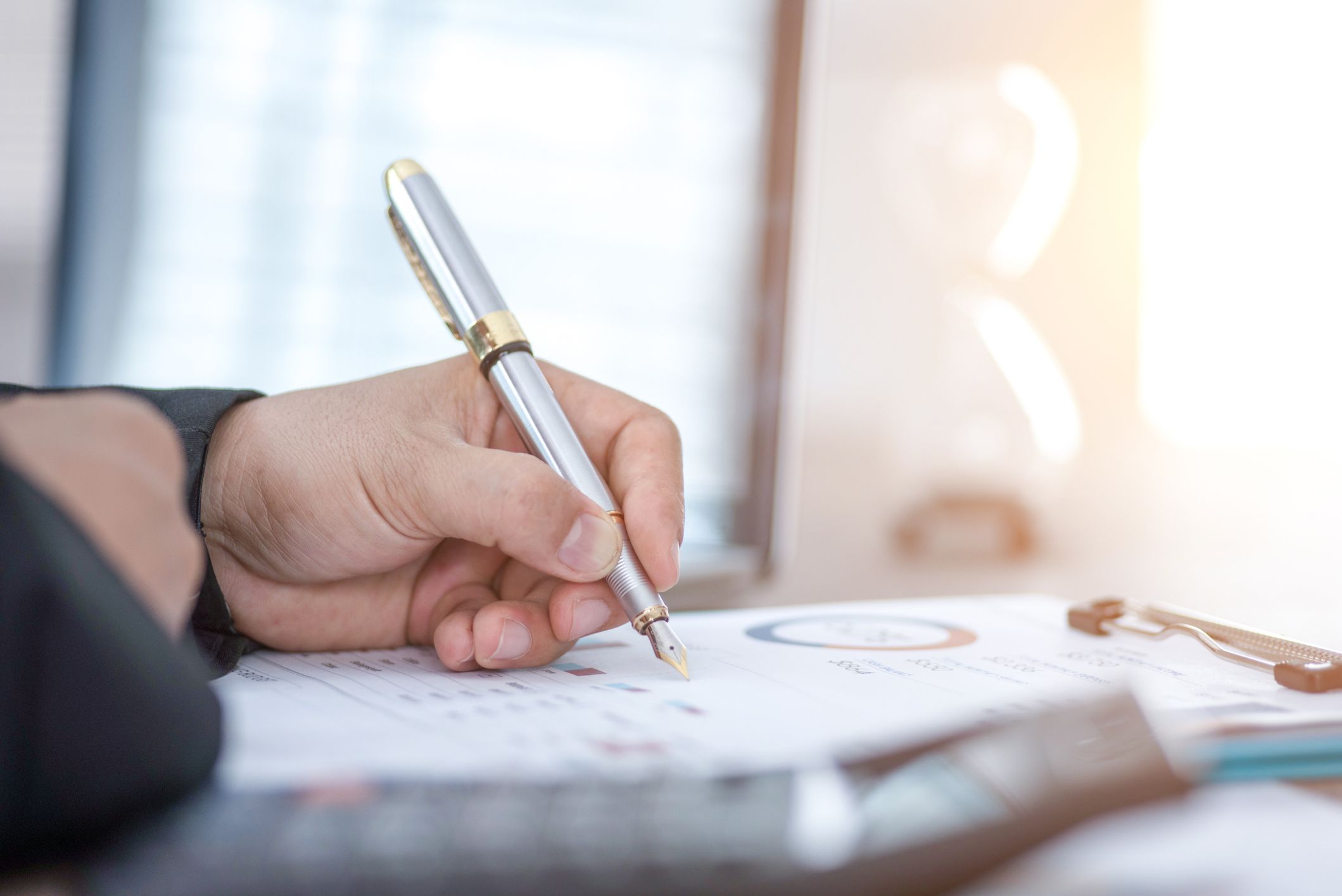 A businessman working on desk office with business documents.